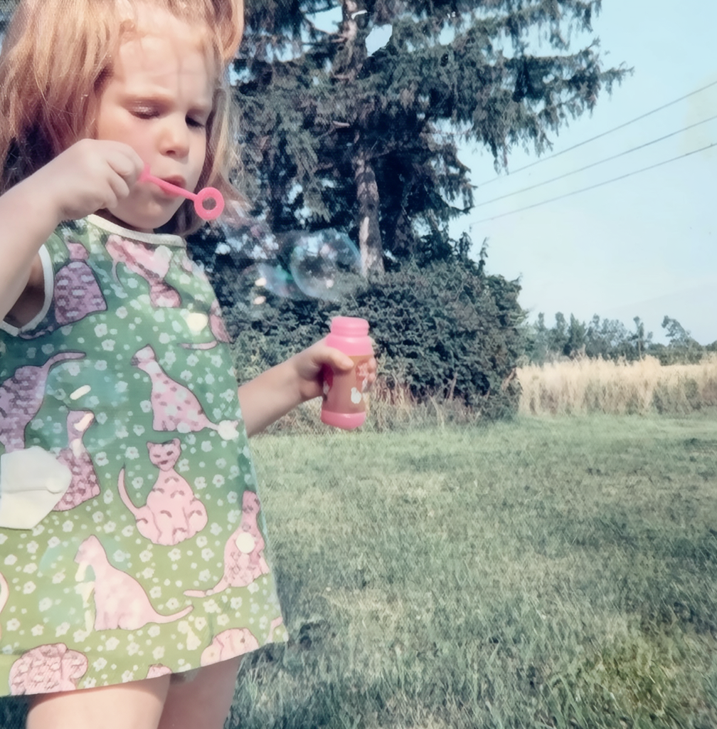 Hanna Arnold at age two, blowing bubbles outdoors
